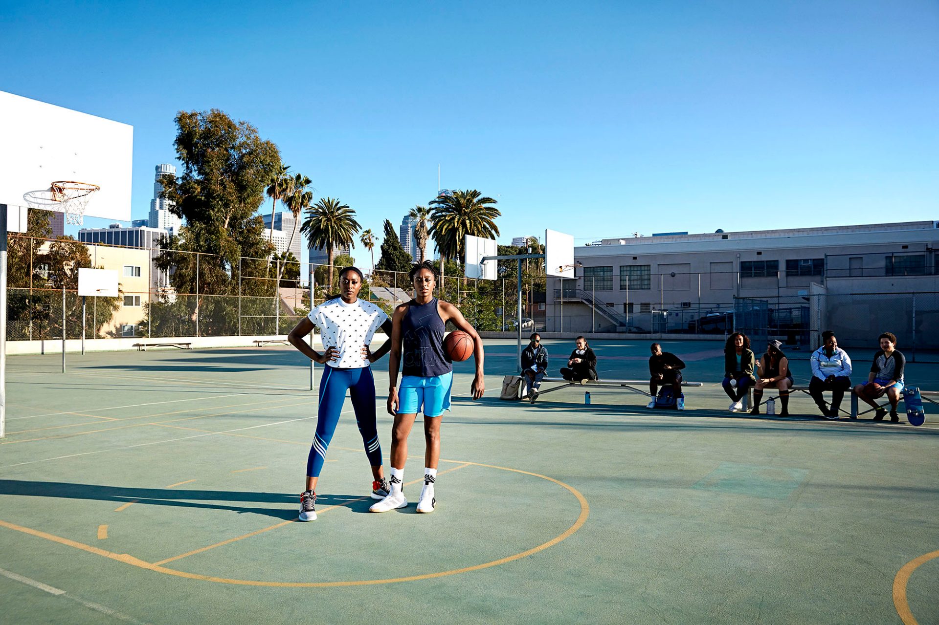 Two women on a basketball court.